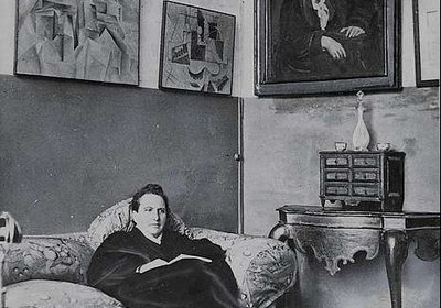 gertrude-stein-sitting-on-a-sofa-in-her-paris-studio-54d8c0-640