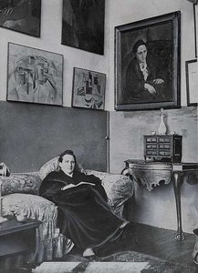 gertrude-stein-sitting-on-a-sofa-in-her-paris-studio-54d8c0-640